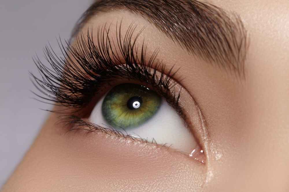 Beautiful macro shot of female eye with extreme long eyelashes and black liner makeup